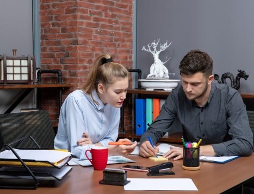 front-view-young-motivated-hardworking-office-team-focused-one-issue-office-enviroment_140725-106017