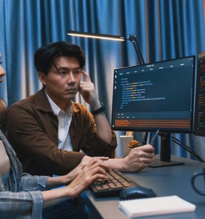 it-developers-discussing-with-point-website-coding-system-infobahn_31965-354793